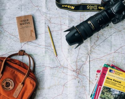 Backback, travel books, map and camera for travelling