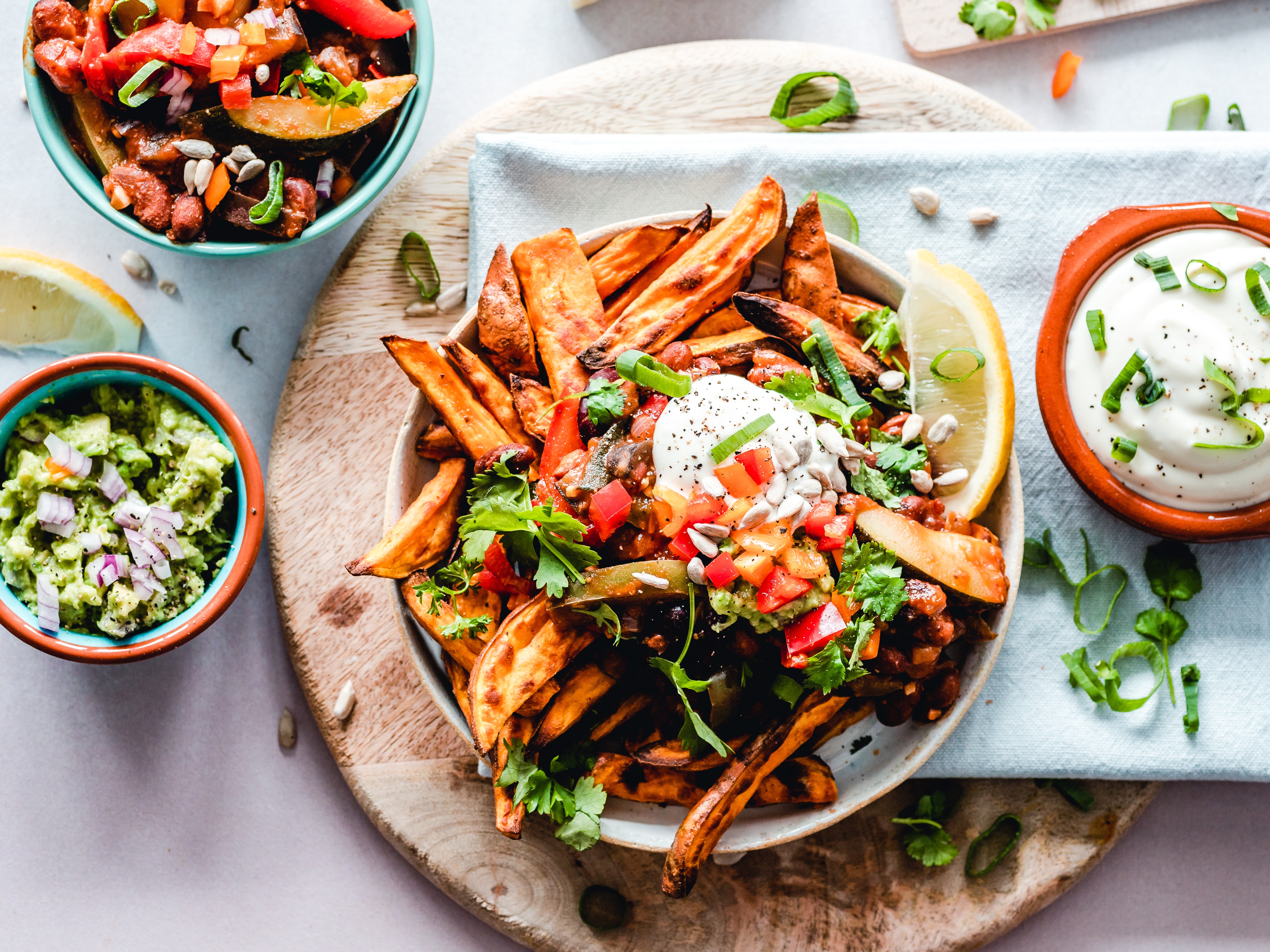 Several plates of vegan food and dips