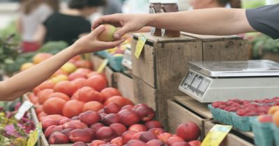 Unidentified person buying fruit from local market