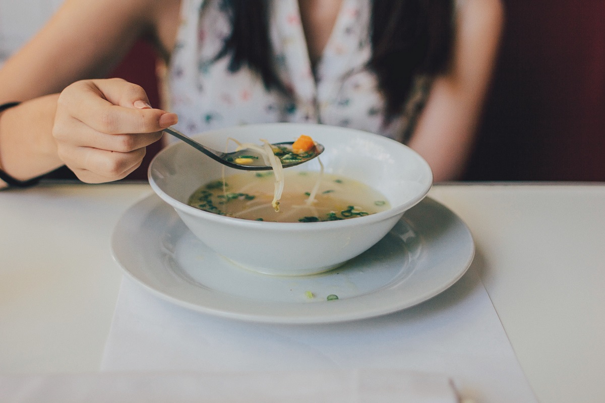 Person eating vegan soup