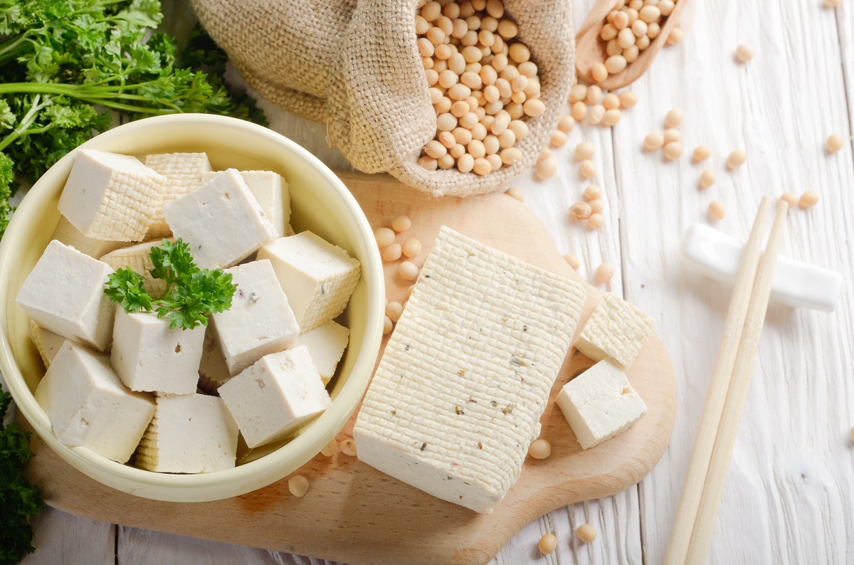 Soy Bean curd tofu in clay bowl and in hemp sack on white wooden