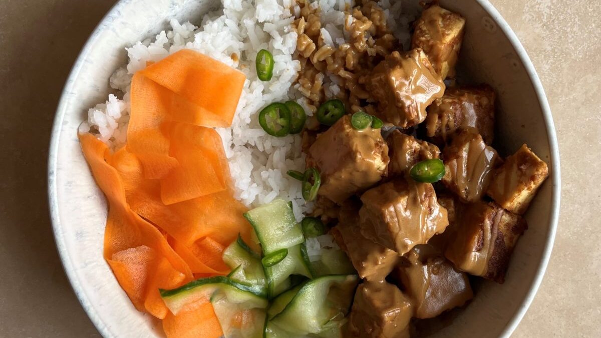 vegan peanut tofu marinade in a bowl of rice and vegetables
