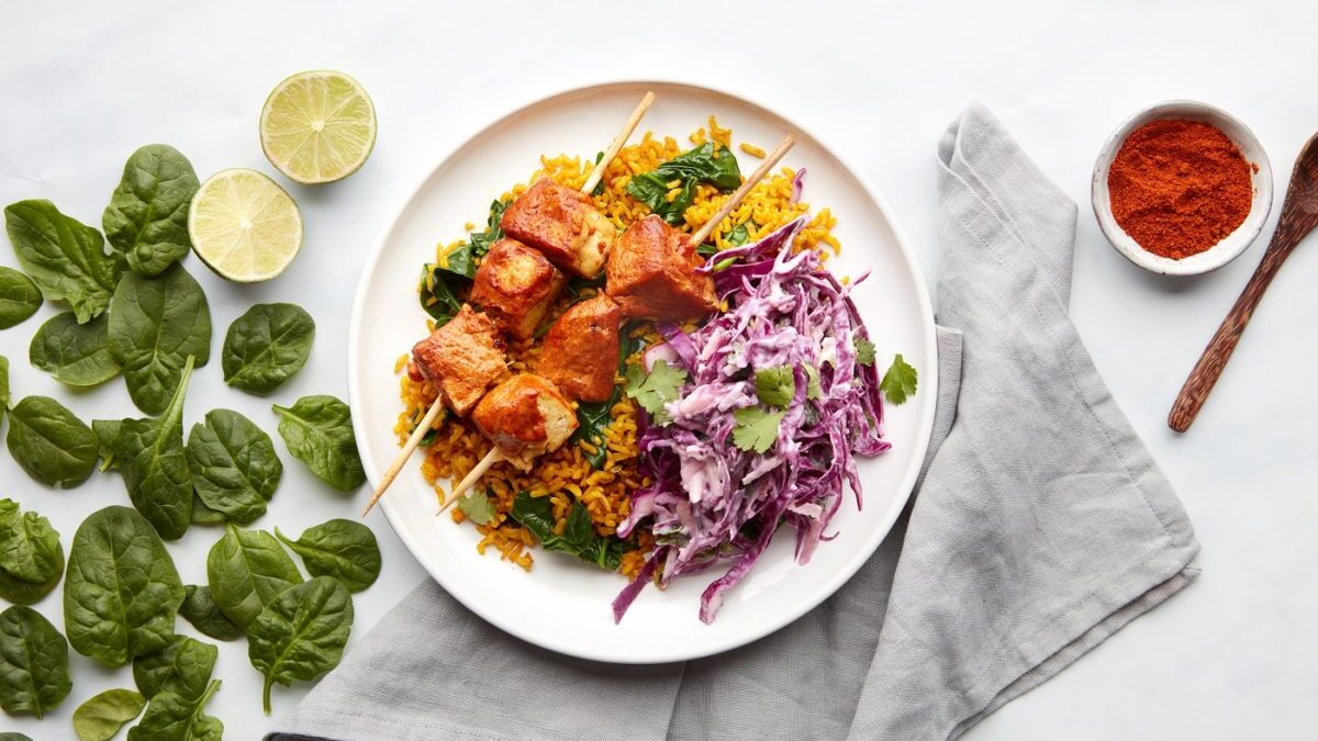 skewered tofu with tikka smoked marinade on a bed of rice and apple slaw